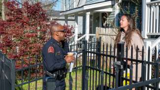 Raleigh Police Chief Rico Boyce speaks to a resident in her yard during a Cops on the Block event.